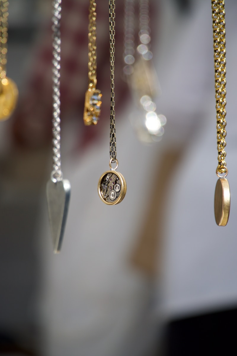 gold-and-silver-colored pendant necklace