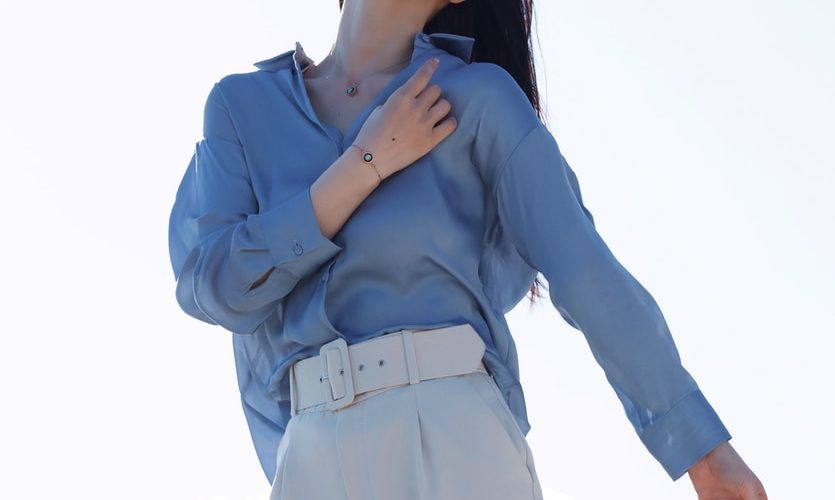 woman in blue long sleeve shirt and white pants