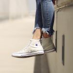 woman wearing white Converse low-top sneakers