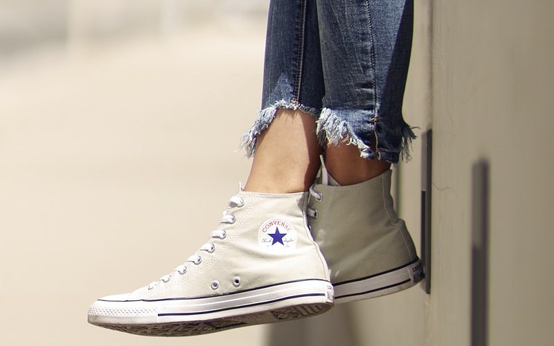 woman wearing white Converse low-top sneakers