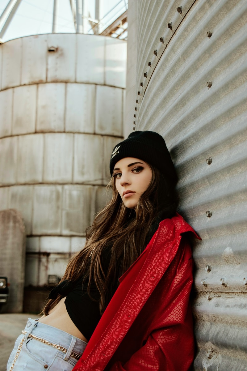 woman in black knit cap and red scarf