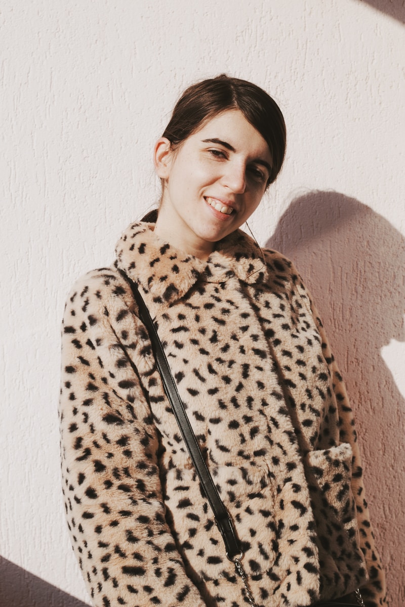 woman in brown and black leopard coat