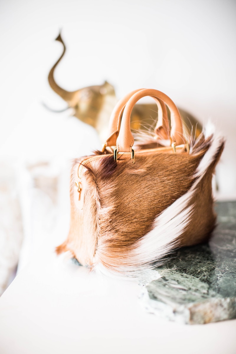selective focus photography of brown and white leather handbag