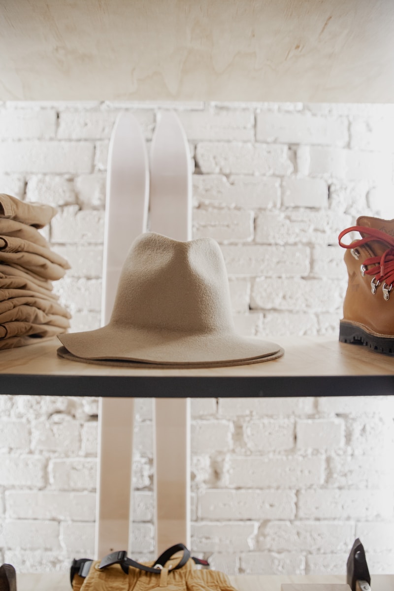 brown cowboy hat on black wooden shelf