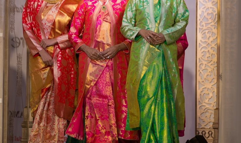 women in green and red traditional dress