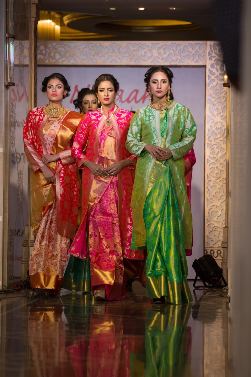 women in green and red traditional dress