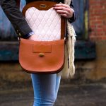woman wearing red leather crossbody bag