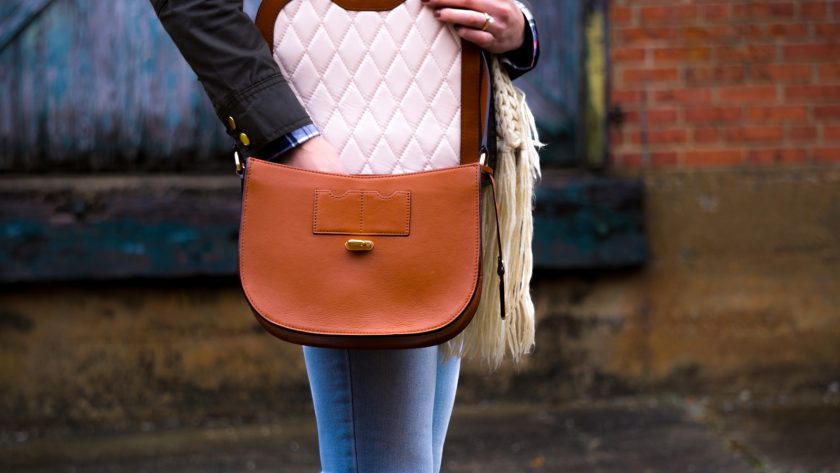 woman wearing red leather crossbody bag