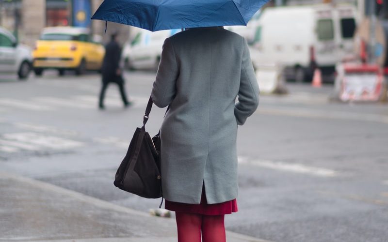 woman standing and holding umbrella