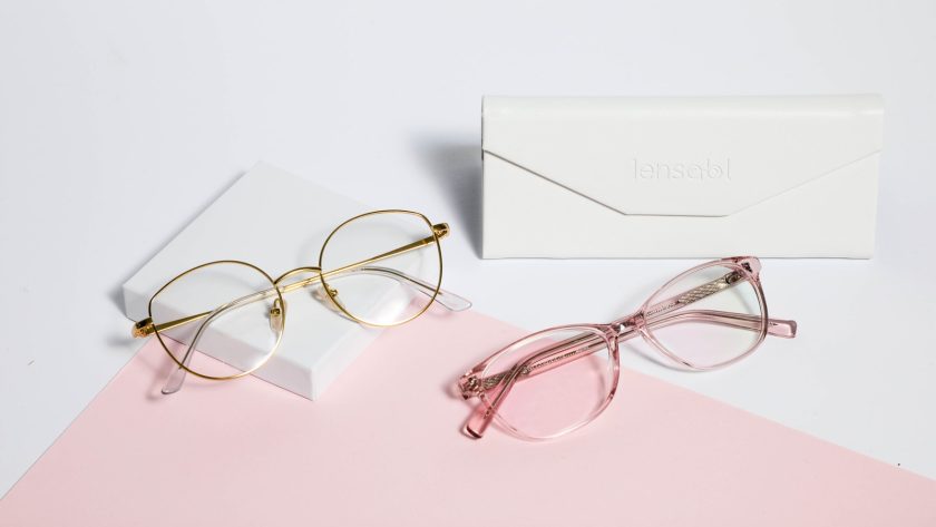 gold framed eyeglasses on white paper