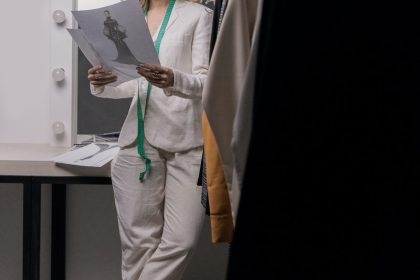 woman in white blazer and white pants standing beside white table